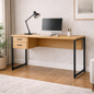 Wooden desk with black legs in a home office setting