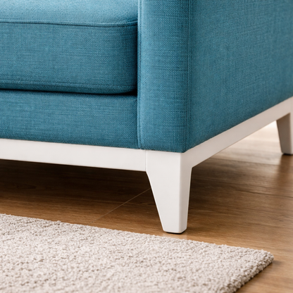 Blue sofa with white legs on a wooden floor
