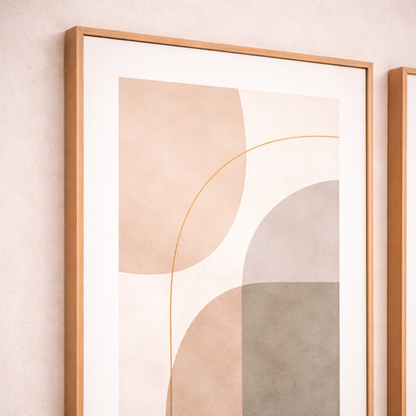 Framed abstract art with geometric shapes on a light pink wall